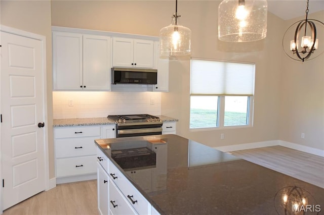 8748 Wendell Creek Dr, Saint Jacob, IL 62281 - kitchen with stainless steel appliances, decorative backsplash, light wood-style flooring, white cabinets, and decorative light fixtures