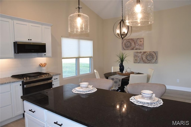 8748 Wendell Creek Dr, Saint Jacob, IL 62281 - kitchen with stainless steel appliances, decorative backsplash, white cabinetry, dark stone counters, and vaulted ceiling
