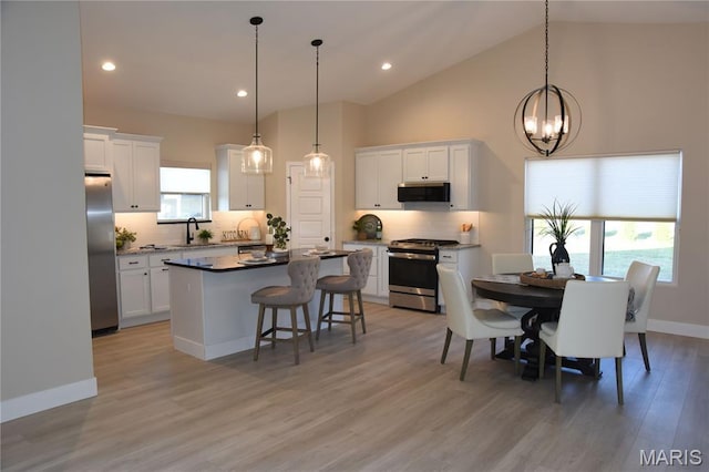 8748 Wendell Creek Dr, Saint Jacob, IL 62281 - dining room featuring a chandelier, light wood-style floors, recessed lighting, and high vaulted ceiling
