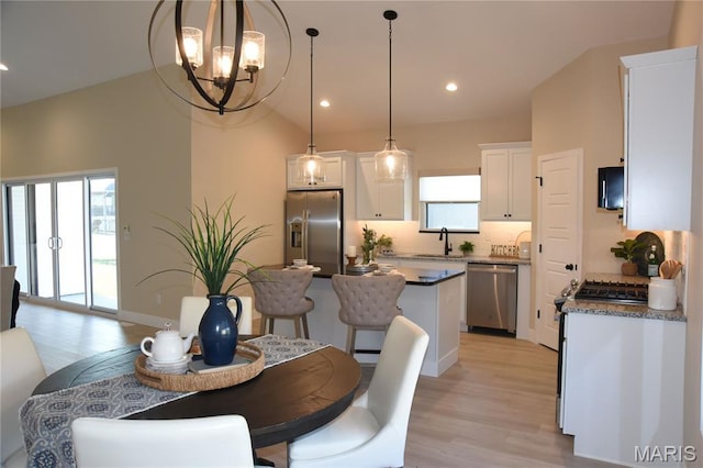 8748 Wendell Creek Dr, Saint Jacob, IL 62281 - dining space with light wood-style flooring, a chandelier, recessed lighting, and vaulted ceiling
