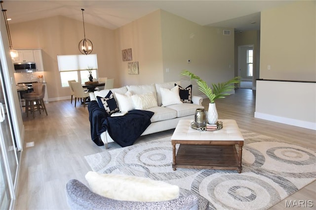 8748 Wendell Creek Dr, Saint Jacob, IL 62281 - living area featuring light wood-style flooring, a chandelier, and lofted ceiling