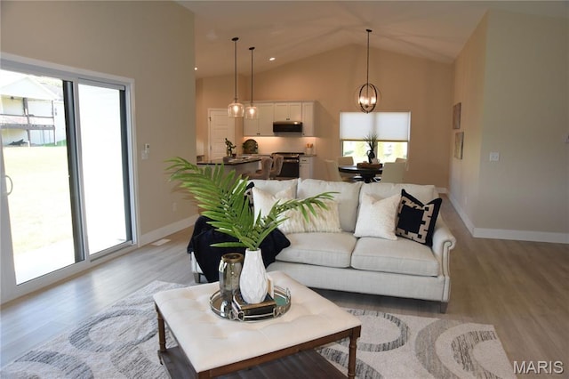 8748 Wendell Creek Dr, Saint Jacob, IL 62281 - living area with a chandelier, high vaulted ceiling, and light wood-style floors