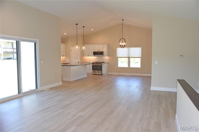 8748 Wendell Creek Dr, Saint Jacob, IL 62281 - unfurnished living room with light wood finished floors, a chandelier, and high vaulted ceiling