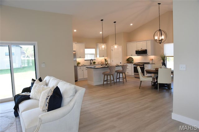 8748 Wendell Creek Dr, Saint Jacob, IL 62281 - living area featuring a chandelier, light wood-type flooring, lofted ceiling, and recessed lighting