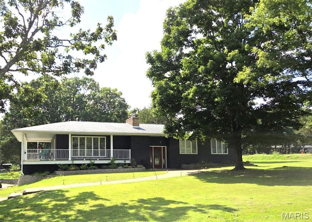 14875 County Road 2310, St James, MO 65559 - view of front of home with a front yard, a chimney, and a sunroom
