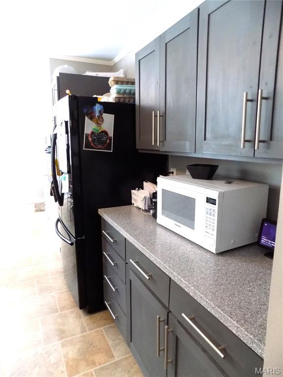14875 County Road 2310, St James, MO 65559 - kitchen featuring white microwave and ornamental molding