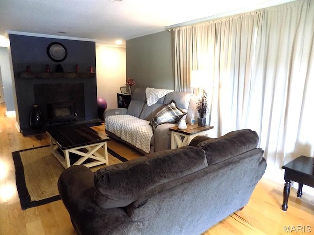 14875 County Road 2310, St James, MO 65559 - living area with plenty of natural light, wood finished floors, a fireplace, and crown molding