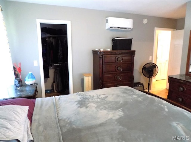 14875 County Road 2310, St James, MO 65559 - bedroom featuring a wall mounted air conditioner, a spacious closet, and a closet