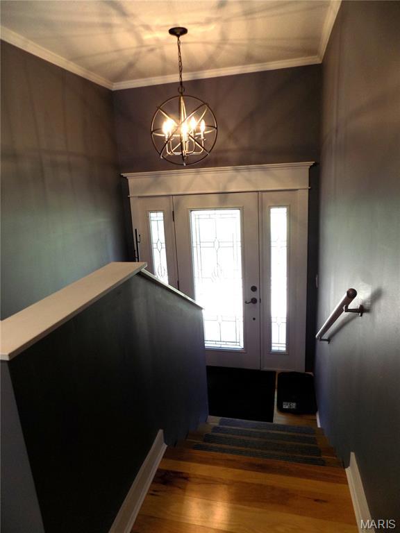 14875 County Road 2310, St James, MO 65559 - foyer entrance with a chandelier, wood finished floors, plenty of natural light, and ornamental molding