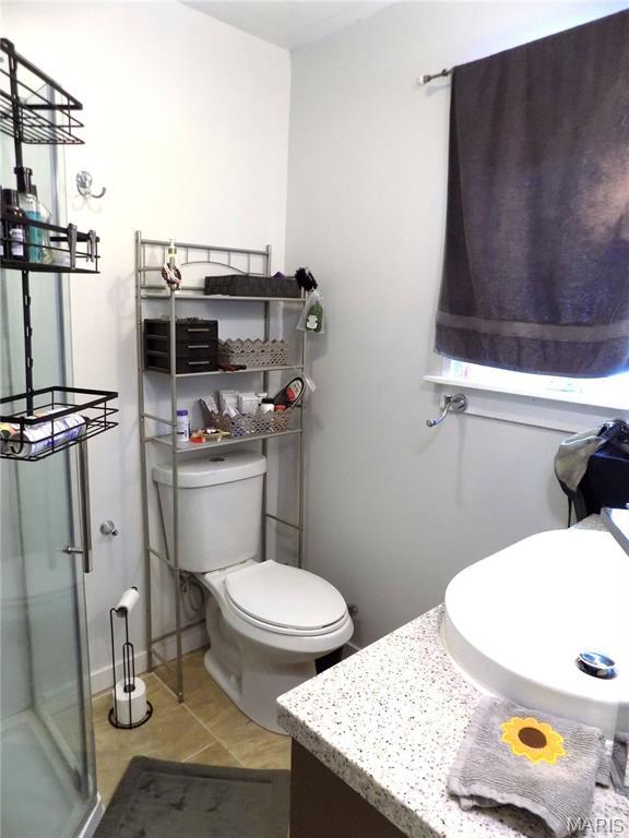 14875 County Road 2310, St James, MO 65559 - bathroom with vanity, a shower stall, and tile patterned floors