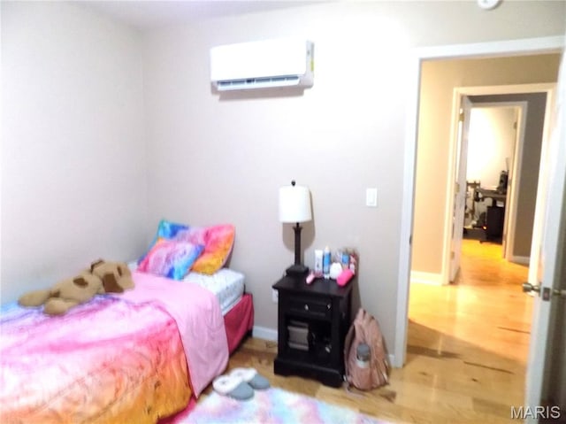 14875 County Road 2310, St James, MO 65559 - bedroom with a wall unit AC and wood finished floors