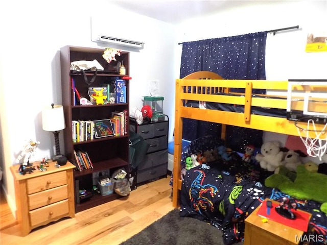 14875 County Road 2310, St James, MO 65559 - bedroom featuring a wall mounted AC and wood finished floors