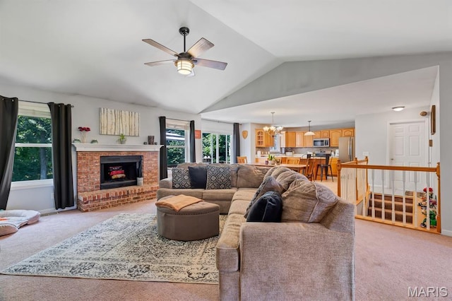 25 Saint Kathleen Ct, Troy, MO 63379 - living area with light colored carpet, vaulted ceiling, a ceiling fan, a fireplace, and a chandelier