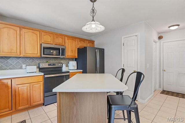 25 Saint Kathleen Ct, Troy, MO 63379 - kitchen with appliances with stainless steel finishes, a kitchen breakfast bar, light tile patterned floors, light countertops, and decorative light fixtures