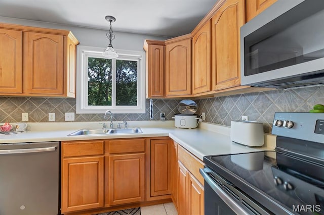 25 Saint Kathleen Ct, Troy, MO 63379 - kitchen featuring appliances with stainless steel finishes, decorative backsplash, light countertops, and pendant lighting