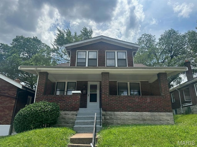 7130 Edison Ave, Saint Louis, MO 63121 - bungalow-style home with brick siding and a porch