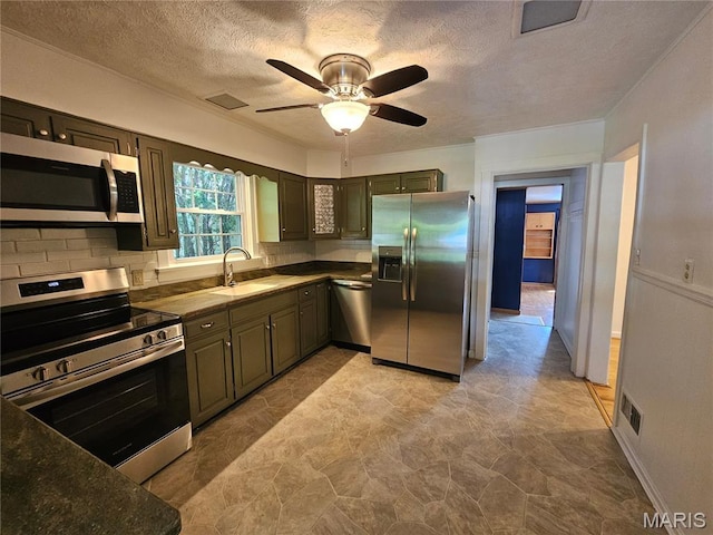 202 Harris, Steeleville, IL 62288 - kitchen featuring appliances with stainless steel finishes, a ceiling fan, a textured ceiling, and dark countertops