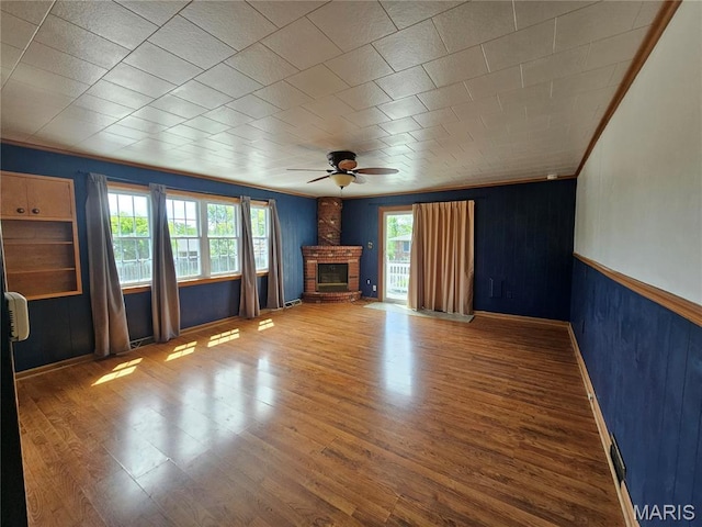 202 Harris, Steeleville, IL 62288 - unfurnished living room with a ceiling fan, wood finished floors, ornamental molding, and wood walls