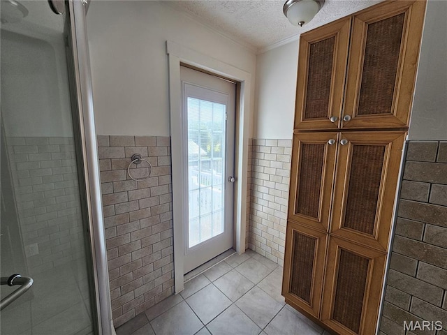 202 Harris, Steeleville, IL 62288 - doorway to outside featuring tile walls, healthy amount of natural light, wainscoting, a textured ceiling, and crown molding
