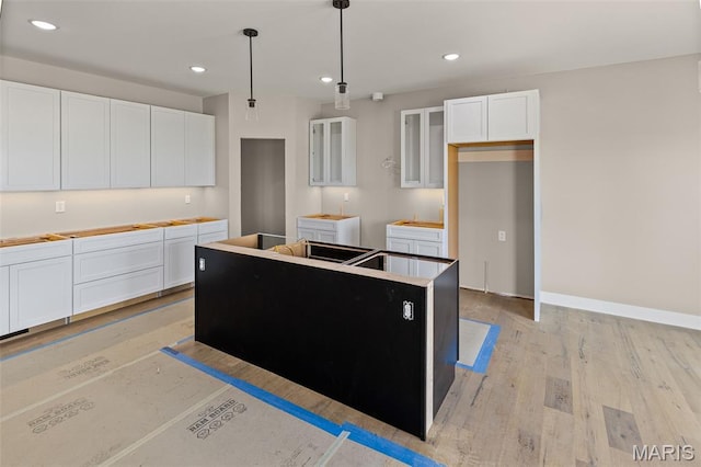 3131 Ashley Dr, Glen Carbon, IL 62034 - kitchen featuring a center island, white cabinets, light wood finished floors, pendant lighting, and recessed lighting