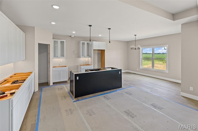 3131 Ashley Dr, Glen Carbon, IL 62034 - kitchen with white cabinets, recessed lighting, a center island, and decorative light fixtures