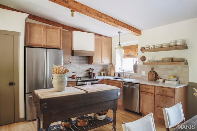 10 Marcus Dr, Saint Peters, MO 63376 - kitchen with stainless steel appliances, open shelves, light countertops, light wood-type flooring, and tasteful backsplash