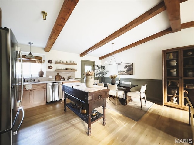10 Marcus Dr, Saint Peters, MO 63376 - kitchen featuring appliances with stainless steel finishes, light wood finished floors, decorative light fixtures, and wainscoting