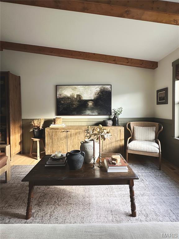 10 Marcus Dr, Saint Peters, MO 63376 - living area with beam ceiling, wood finished floors, and a wainscoted wall