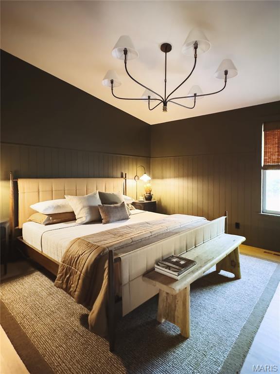 10 Marcus Dr, Saint Peters, MO 63376 - bedroom featuring a chandelier and wooden walls