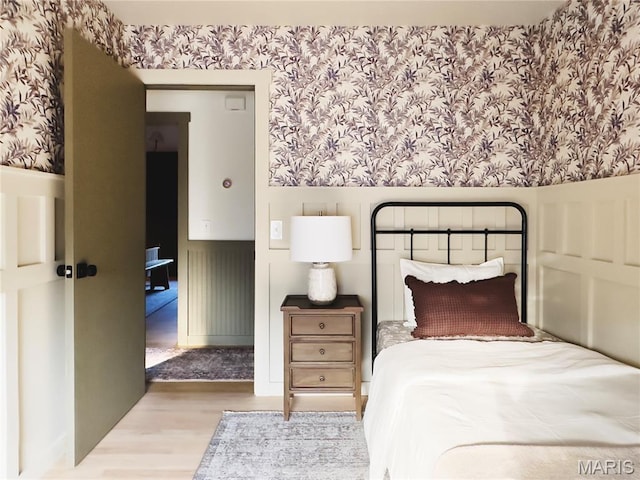 10 Marcus Dr, Saint Peters, MO 63376 - bedroom with wallpapered walls, wood finished floors, and wainscoting