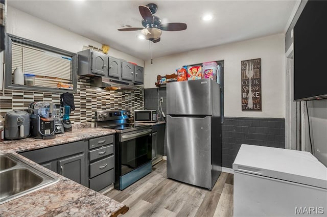 5211 Fletcher St, Jennings, MO 63136 - kitchen featuring appliances with stainless steel finishes, under cabinet range hood, gray cabinets, ceiling fan, and light wood-style flooring