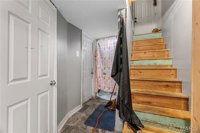 5211 Fletcher St, Jennings, MO 63136 - stairway with baseboards and stone finish floors