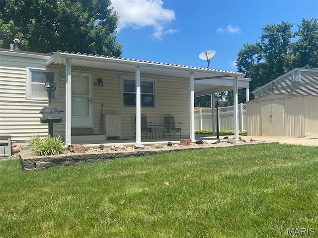 4828 Plum Tree Ln, Hazelwood, MO 63042 - back of property featuring a shed, a yard, and covered porch