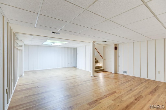 4828 Plum Tree Ln, Hazelwood, MO 63042 - finished below grade area featuring stairs, light wood finished floors, and a paneled ceiling