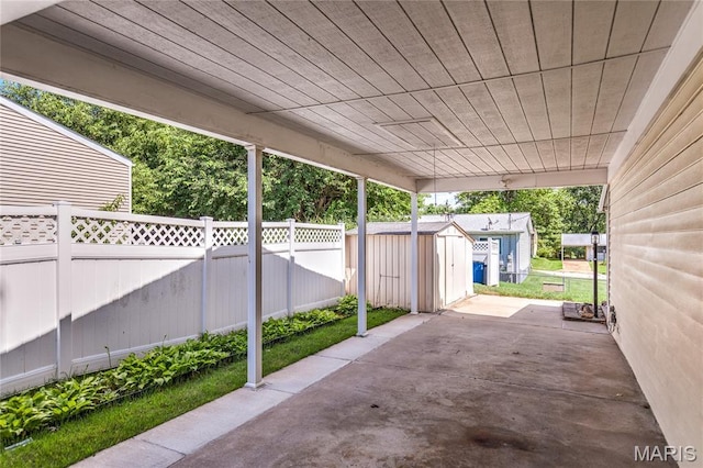 4828 Plum Tree Ln, Hazelwood, MO 63042 - fenced backyard featuring a storage unit and a patio