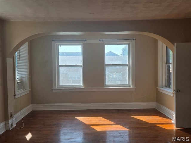 3421 Belt Ave, Saint Louis, MO 63120 - spare room featuring wood finished floors, plenty of natural light, and arched walkways