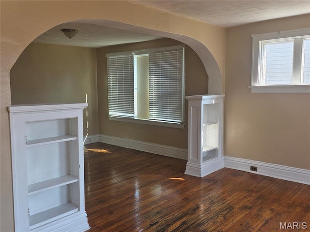 3421 Belt Ave, Saint Louis, MO 63120 - unfurnished living room featuring wood finished floors and arched walkways