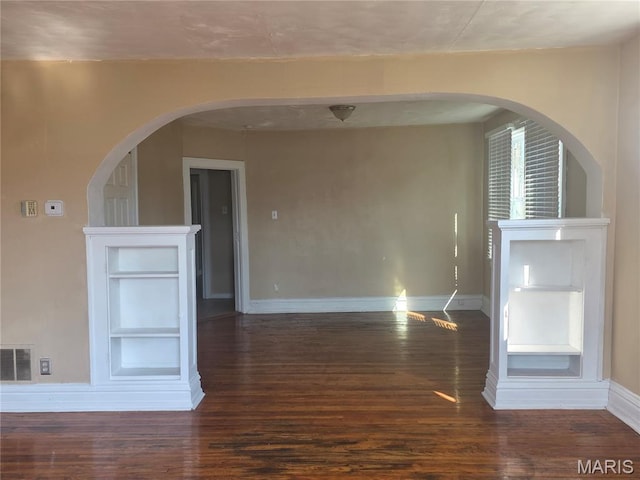 3421 Belt Ave, Saint Louis, MO 63120 - unfurnished living room with wood finished floors and arched walkways