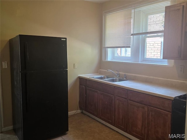 3421 Belt Ave, Saint Louis, MO 63120 - kitchen featuring freestanding refrigerator, range, light tile patterned floors, and light countertops