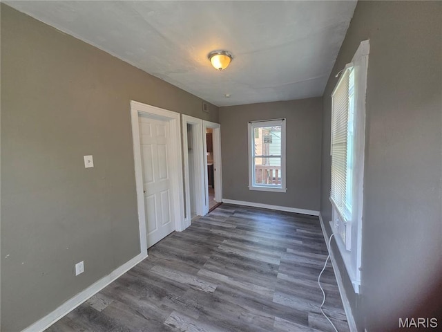 3421 Belt Ave, Saint Louis, MO 63120 - unfurnished bedroom featuring baseboards and dark wood-style floors