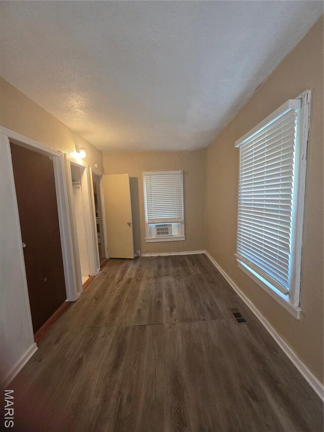 3421 Belt Ave, Saint Louis, MO 63120 - unfurnished living room featuring wood finished floors and baseboards