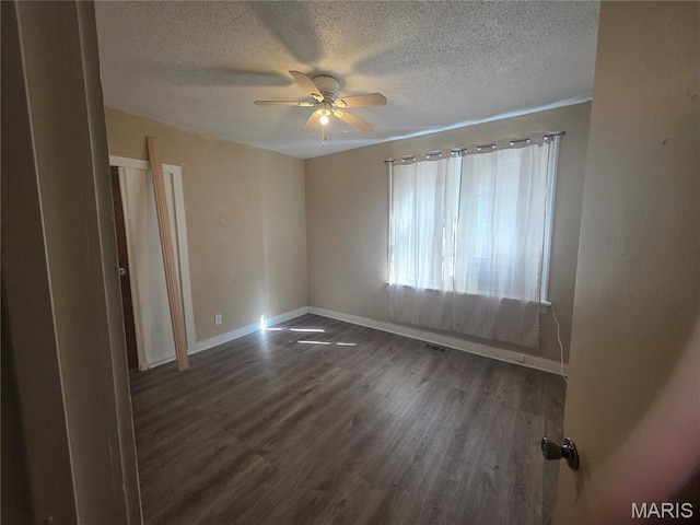 3421 Belt Ave, Saint Louis, MO 63120 - empty room with a textured ceiling, ceiling fan, and dark wood-type flooring