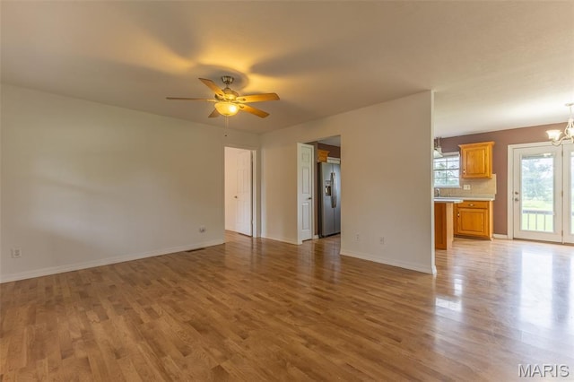 136 County Road 4415, Poplar Bluff, MO 63901 - unfurnished living room featuring light wood-style floors, a chandelier, and ceiling fan