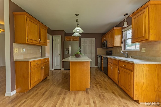 136 County Road 4415, Poplar Bluff, MO 63901 - kitchen with appliances with stainless steel finishes, light countertops, light wood finished floors, a center island, and backsplash