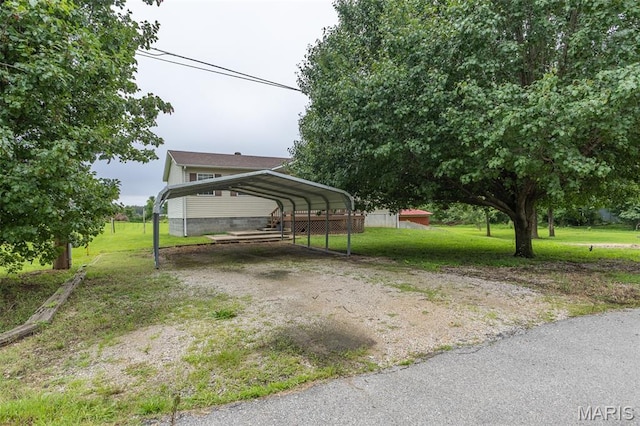 136 County Road 4415, Poplar Bluff, MO 63901 - view of green lawn with a detached carport and dirt driveway