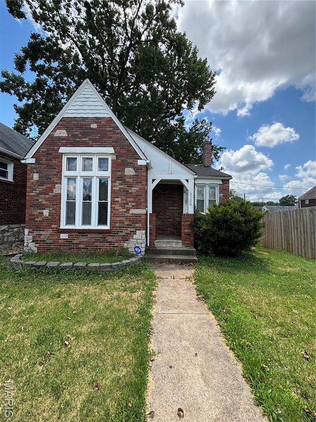 6104 N Pointe Blvd, Saint Louis, MO 63147 - bungalow-style house featuring a chimney and brick siding
