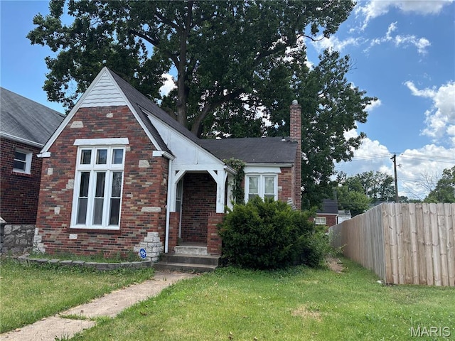 6104 N Pointe Blvd, Saint Louis, MO 63147 - english style home featuring a chimney and brick siding