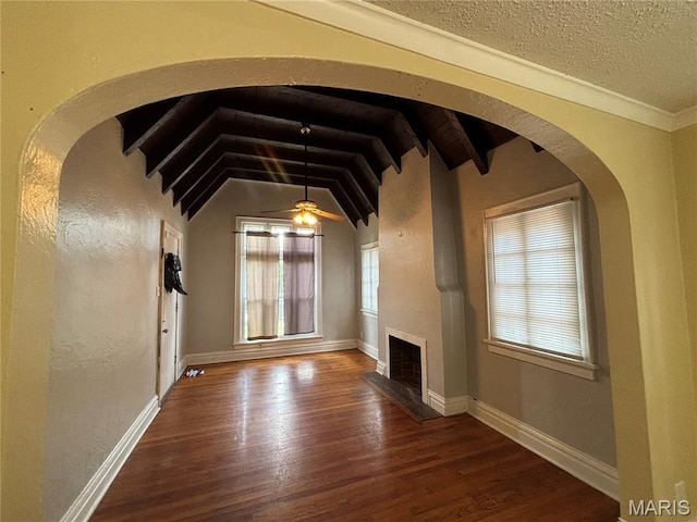6104 N Pointe Blvd, Saint Louis, MO 63147 - unfurnished living room with wood finished floors, a fireplace, a ceiling fan, arched walkways, and a textured wall