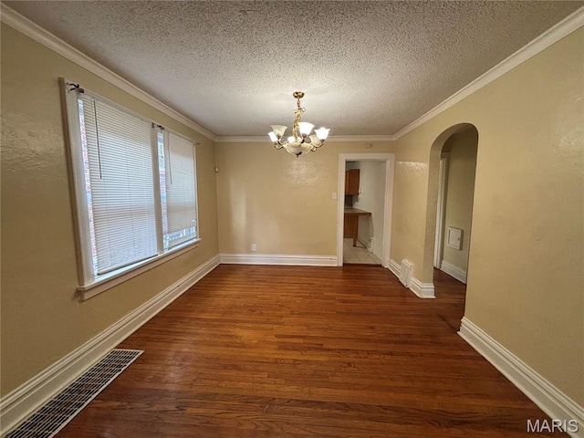 6104 N Pointe Blvd, Saint Louis, MO 63147 - unfurnished dining area with arched walkways, a chandelier, a textured ceiling, dark wood-style floors, and ornamental molding