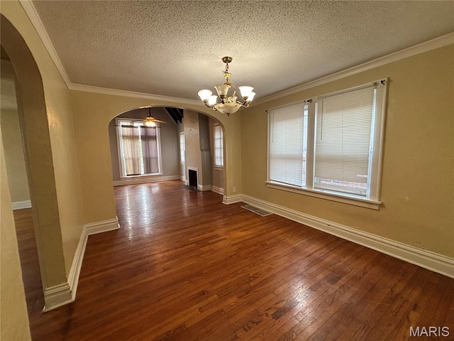 6104 N Pointe Blvd, Saint Louis, MO 63147 - spare room with arched walkways, hardwood / wood-style flooring, a chandelier, a textured ceiling, and ornamental molding